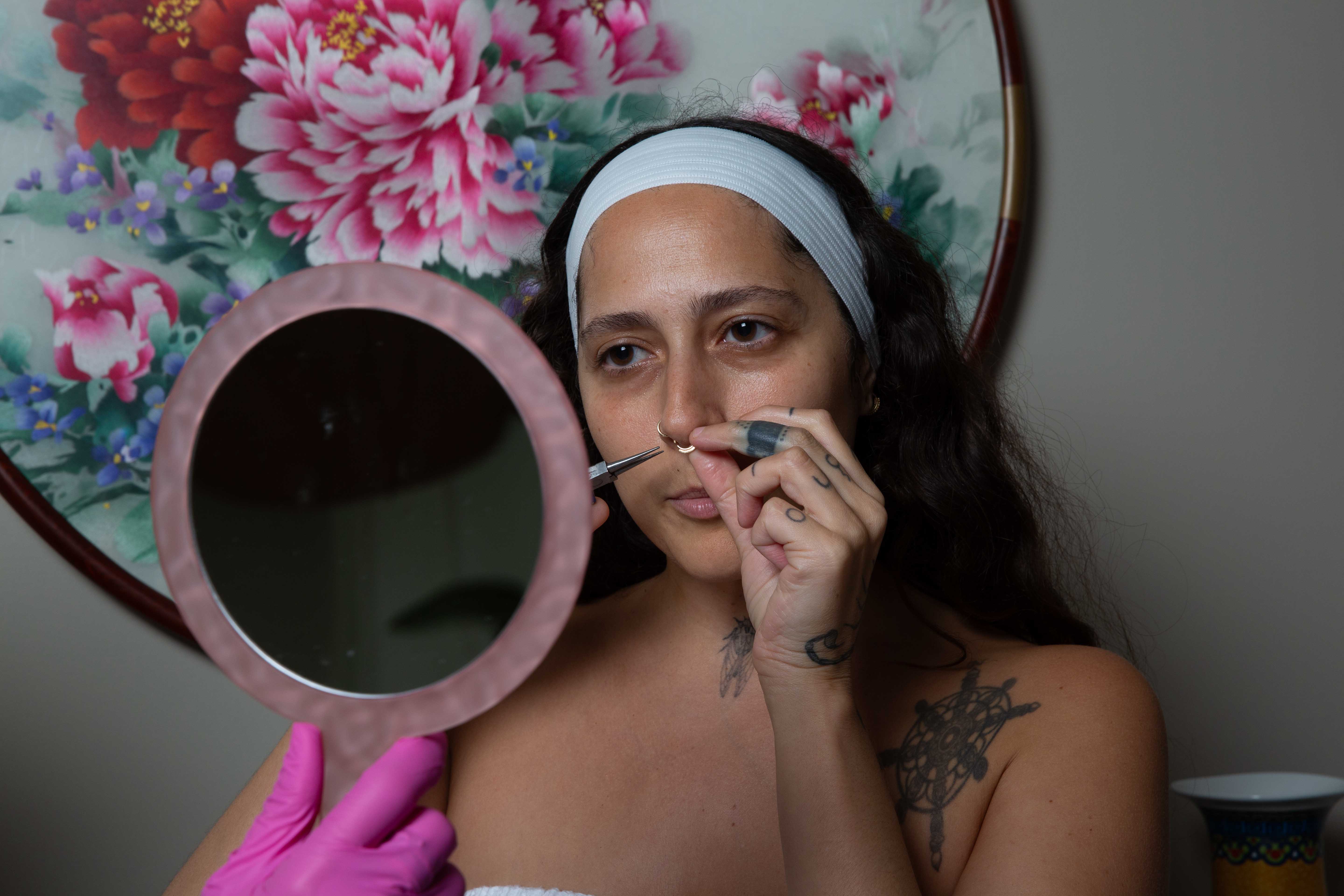 Post-care mirror moment after clinical skincare for a West End Richmond patient